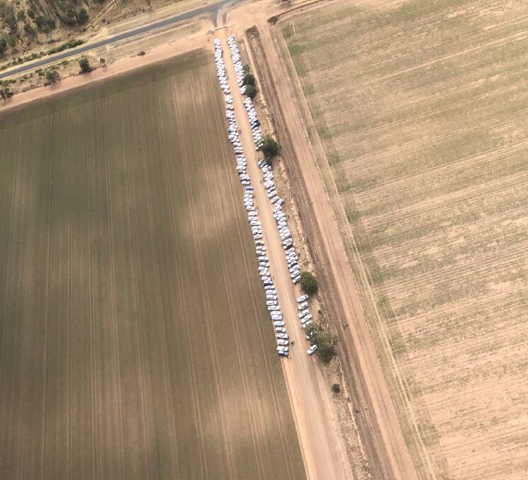 The mourners line up in their cars as a tribute to Barb Glennie near her home at Norwood, outside Moree. Photo by Craig Estens.