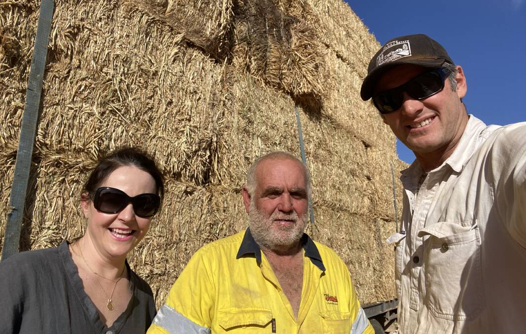 Sara Jackson with Rural Aid driver David Moore and Matt Jackson as the hay arrived.
