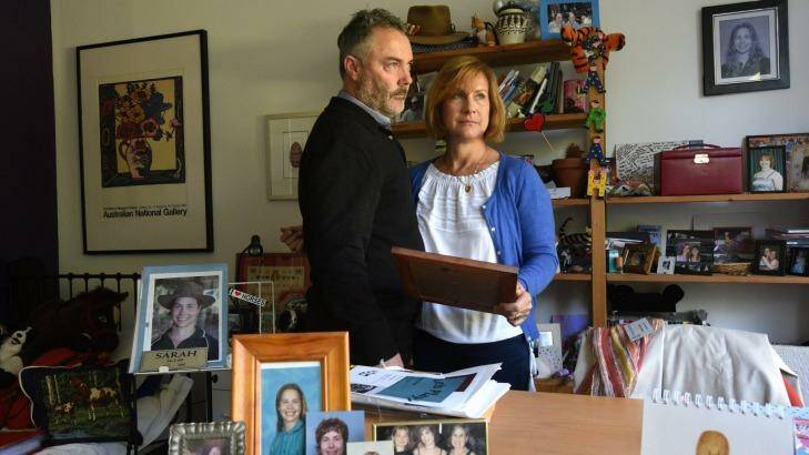 Mark and Juliana Waugh in their home with photos of Sarah.