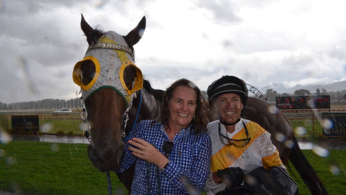 No matter what the weather, Greg Ryan and Amelia Lundholm celebrate a win with Sprezzatura at a wet Mudgee day. Photo Virginia Harvey
Greg Ryan celebrates a win with Wyong conditioner Damien Lane on Scone Cup day. Photo Virginia Harvey.