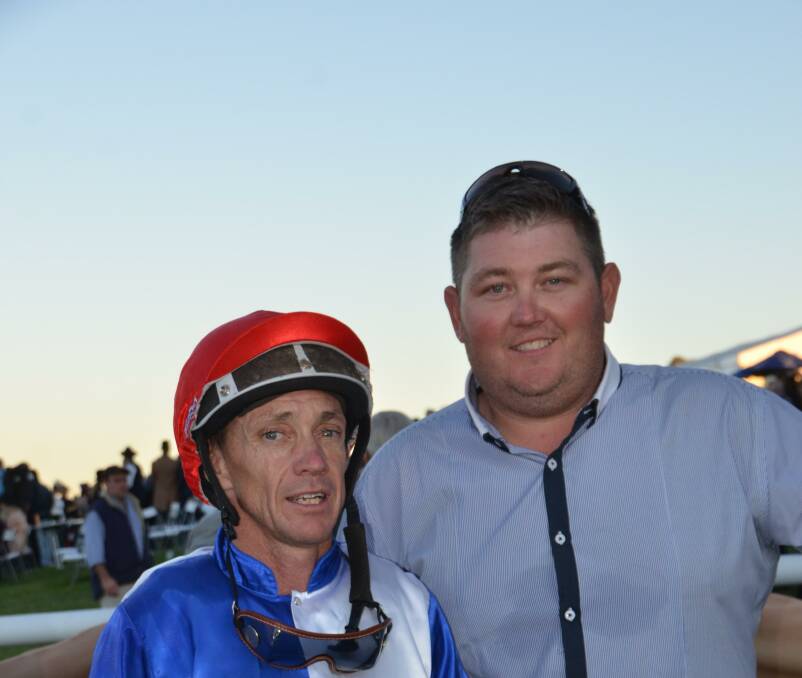 Greg Ryan celebrates a win with Wyong conditioner Damien Lane on Scone Cup day. Photo Virginia Harvey.