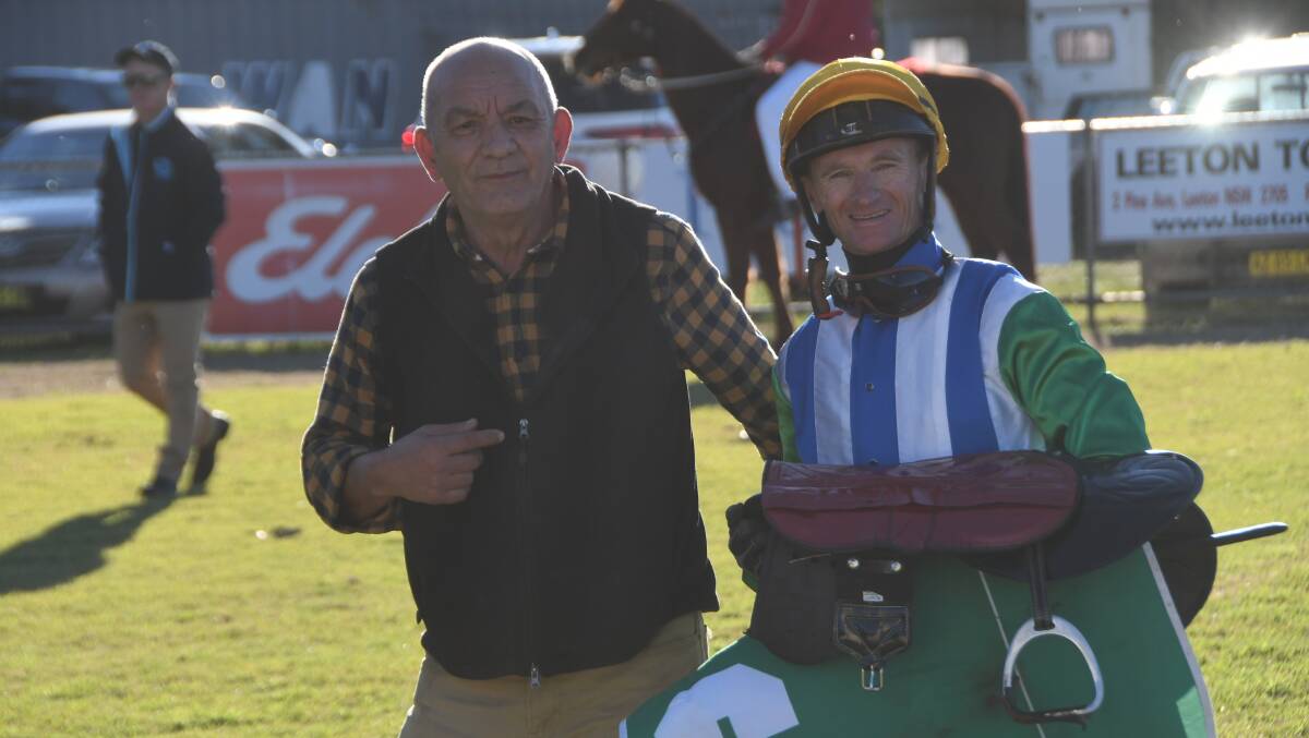  A happy jockey Brendan Ward, with Wagga Wagga trainer George Dimitropoulos following the win of tough campaigner Willy White Socks in the feature event at Narrandera last month. Photo Virginia Harvey. 