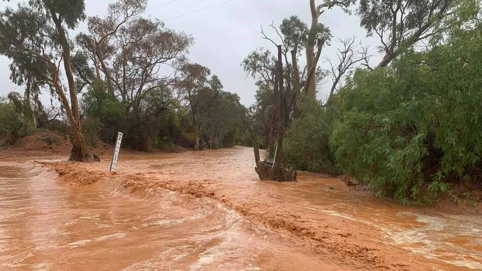 Roads turned into rivers near Silverton today as rain descended on the Broken Hill area. Unfortunately some stations only received a few millimetres. Photo by Silverton artist John Dynon and courtesy of ABC Broken Hill.