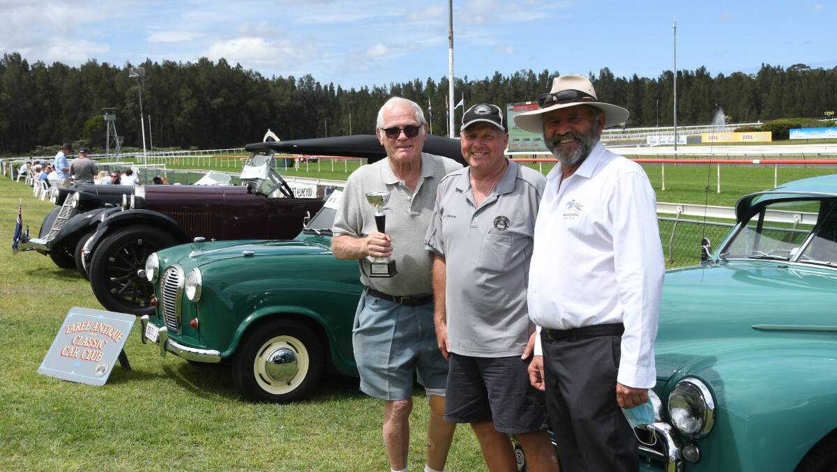 A glimpse of the row of antique cars with James Jumbo Pereira, Trevor Hudson, and Manning River Race Club Committeeman Brian Kelly at the Taree races on Melbourne Cup day. Photo Virginia Harvey.