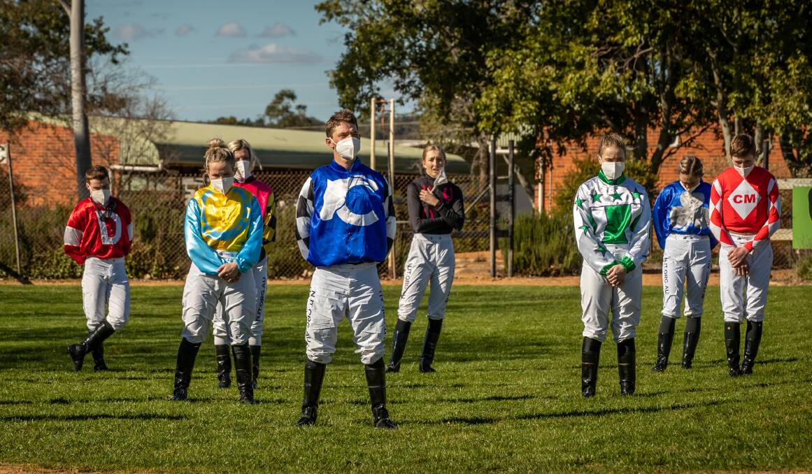Jockeys at Dubbo observe a minute's silence for their colleagues who have died or been badly injured. Photos by Janian McMillan.