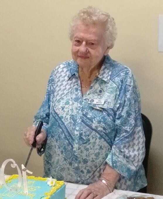 Val cuts her 100th birthday cake.
