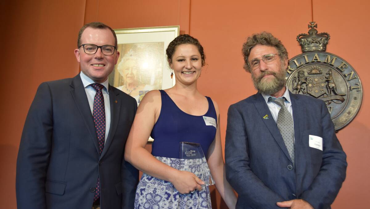 All smiles as the new NSW Young Farmer of the Year, Dorrigo's Renae Connell, accepts her award from NSW Agriculture Minister Adam Marshall and NSW Farmers' president James Jackson.