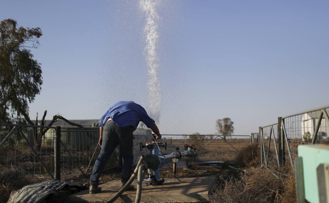 Farmer Ed Colless tests his bore water supply near Walgett. Applications for new bores in NSW rose by a third in one month. Photo by Alex Ellinghausen.