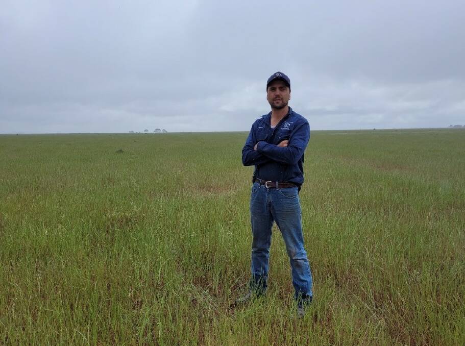 Hay woolgrower Rhys McCulloch and his family were only too happy to be part of the conservation trust program. He's pictured on one of the grazing areas at Bullawah, not the grassland that they have agreed to preserve.