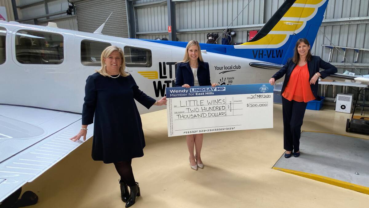 NSW Regional Youth Minister Bronnie Taylor hands over the $200,000 grant from the NSW Government to Little Wings chief executive Clare Pearson, with East Hills MP Wendy Lindsay, at Bankstown aerodrome on Wednesday. The grant will enable Little Wings to keep transporting regional children to hospitals in the city for specialist treatments. Photo by Richard Shute.