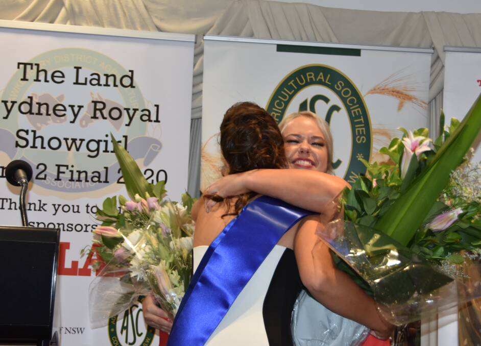 Emily Quinn, at right hugs her co-winner Eliza Babazogli after they were announced as Zone 2 winners of The Land Sydney Royal Showgirl competition and are now off to Sydney Royal - a longtime dream for Milton's Emily Quinn.
