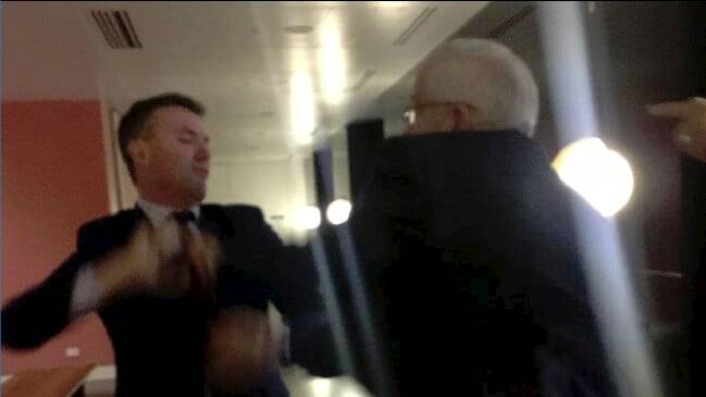 One Nation staffer James Ashby and UAP senator Brian Burston in a confrontation on the marble floor in Federal Parliament on Wednesday night.