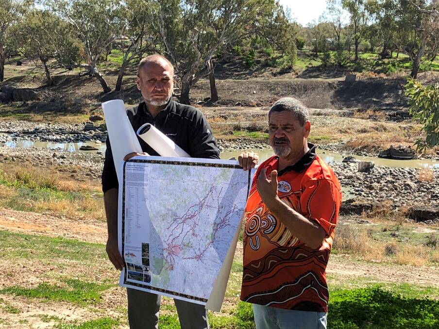  Ngemba traditional owner Jason Ford (l) and Fred Hooper (r) from the Northern Basin Aboriginal Nations, holding one of the maps of significant Aboriginal cultural sites in the northern basin of the Murray-Darling.