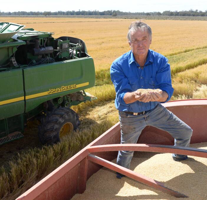 Market fears: SunRice chairman Laurie Arthur, pictured harvesting Reiziq rice on his son's property "Elmsmere", Moulamein, says urgent water reform is needed to protect irrigators and the environment. Photo Rachael Webb.