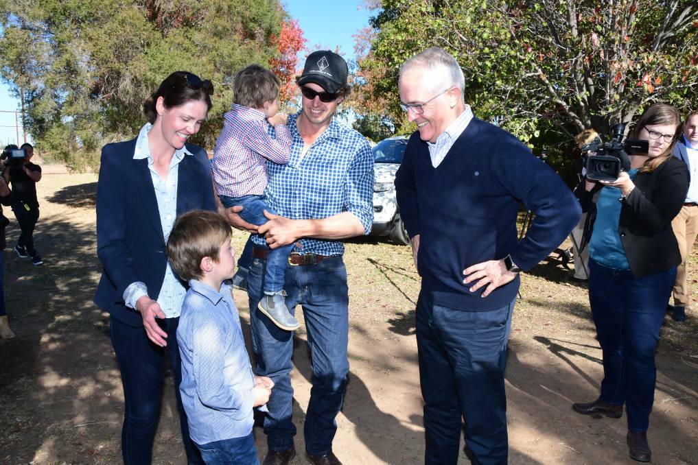 Farmers Ashlea and Phil Miles with children Harry and Jack greeting Malcolm Turnbull at their Strathmore property in Trangie. Photo Belinda Soole.