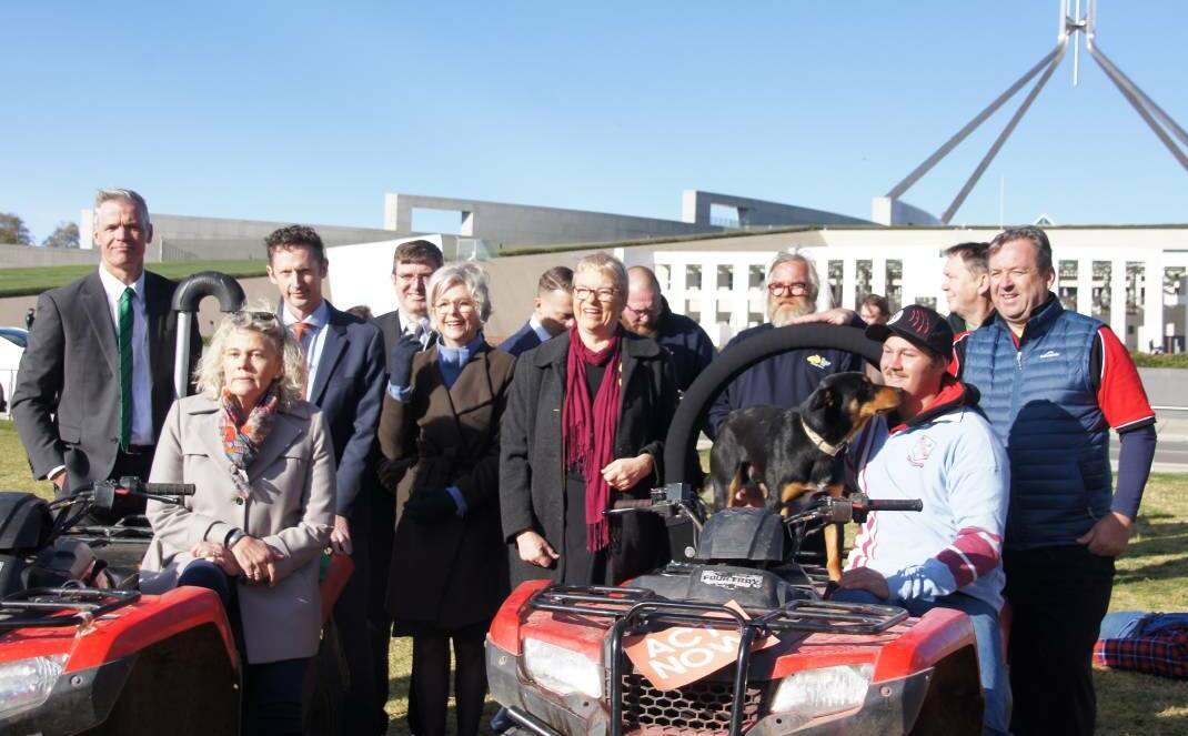 Rural groups, politicians and Slim the dog campaigned for mandatory roll-over protection on the lawns of Parliament House in September.