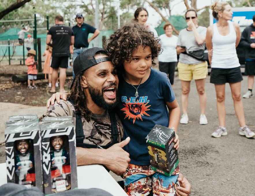 Patty Mills visited the south coast earlier this year to visit fire-affected regions. Picture: Matthew Adekponya