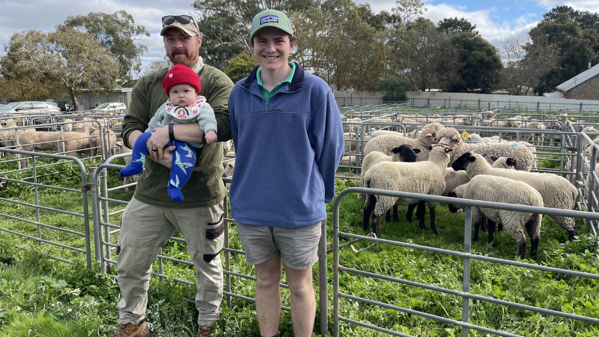 INTERSTATE VISIT: Rob Orwin, with son Louis, 7 months, Mortlake, and Brett Smith, Forreston, SA, sold a pen of Suffolks at Mount Pleasant, SA.