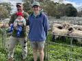 INTERSTATE VISIT: Rob Orwin, with son Louis, 7 months, Mortlake, and Brett Smith, Forreston, SA, sold a pen of Suffolks at Mount Pleasant, SA.