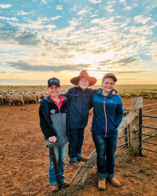 Willow, Sebastian and Grace Wakefield at their White Cliffs station in NSW. Grace is meant to return to Westminster School in SA on Monday but has yet to receive a border crossing exemption. 