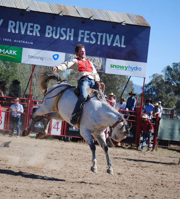 HANGING ON: John Mitchell executed a successful buck jump to clinch the Man From Snowy River Bush Festival open challenge title. Picture: GABBY DODDS