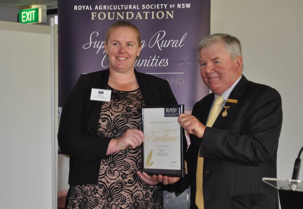 Bridget Lee, a teacher from Forbes, Agricultural Societies Council group 10, receives her award for $10,000 towards a transportable zone for free agricultural-based education for young children, from RASF chairman Michael Millner.