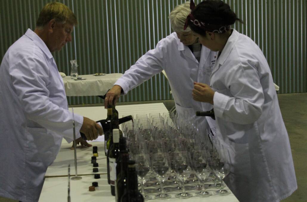 Jacob Stein said that now is the time to think Mudgee wine when buying a drop, pictured is Mudgee Wine Show stewards preparing local wines for judging.