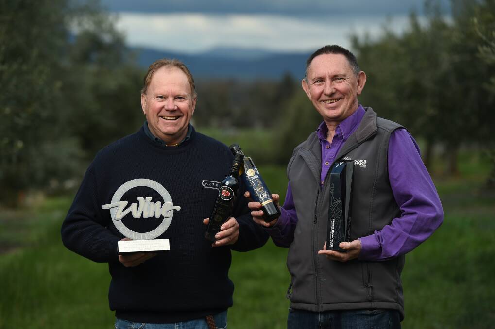 CHEERS: David Morris from Morris Wines and Rob Whyte from Gooramadda Olives celebrate their combined success. The two business owners are neighbours and enjoy working side-by-side.Photo: Mark Jesser.
