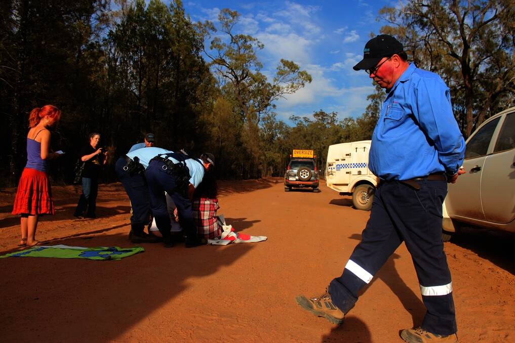 Police arresting protesters blocking Santos’ access to the Pilliga Forest.
