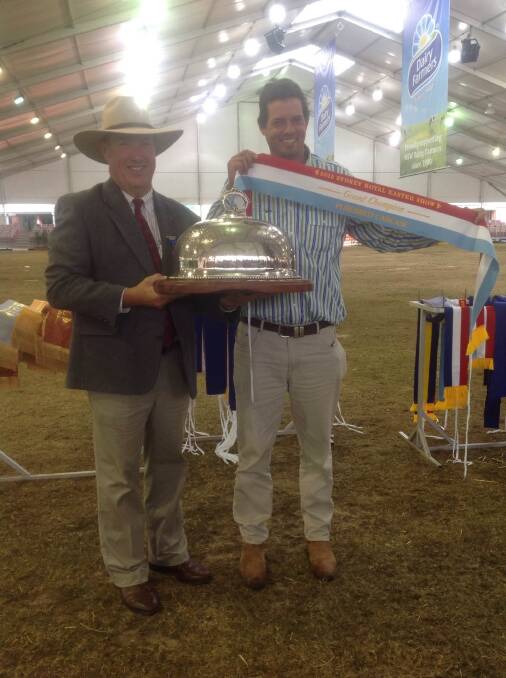 Carcase judge Jeff House presents Lachlan James, Wallawong Murray Greys, Gunnedah, with the grand champion carcase trophy and ribbon.