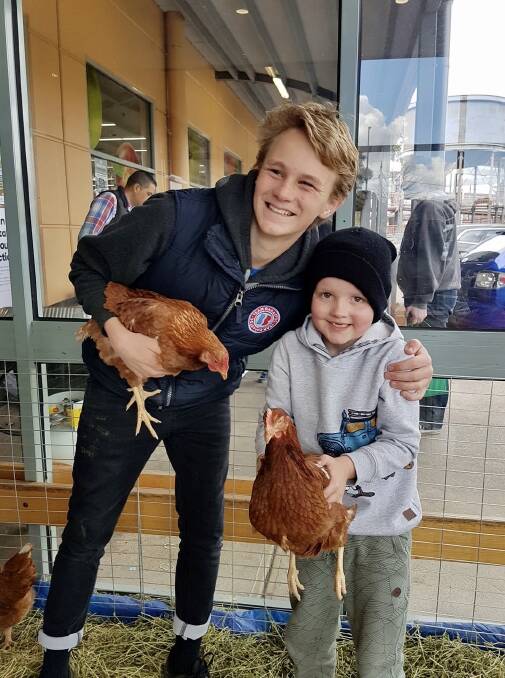 SHARING THE LOVE: Josh showing his chooks to shoppers.