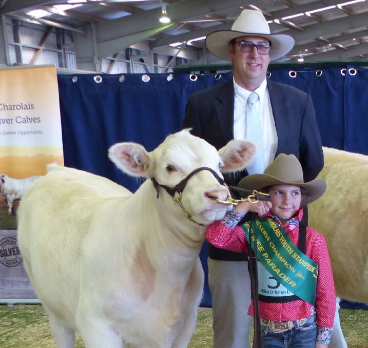 FUN: Miley O'Brien, pictured with judge Roger Evans, was proud to be named reserve champion peewee handler at the 2016 National Charolais Youth Stampede.