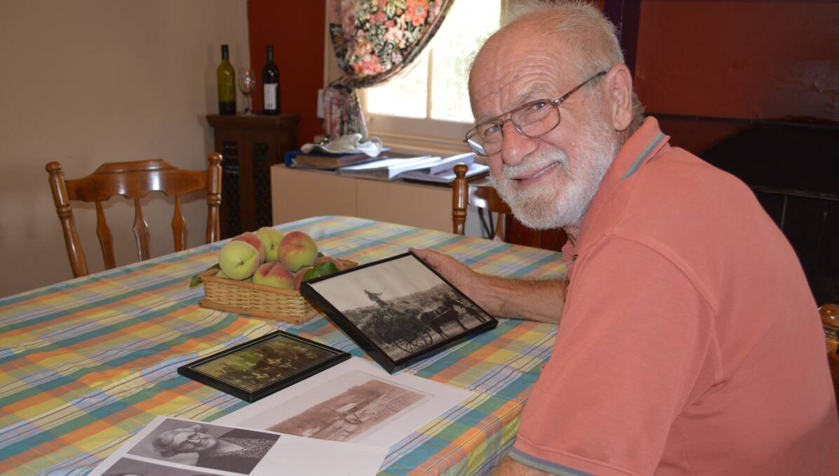 Alan Fragar with historic family photos, including a photo of his grandfather Frank, who developed the Fragar peach.