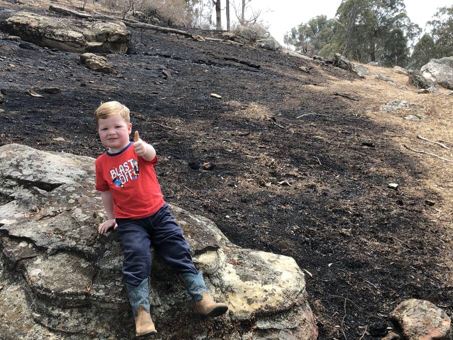 Three-year-old Wyatt Wythes gives a thumbs up for a firey. Wyatt lives right near the Kerry Ridge fire near Rylstone NSW, which has reached a massive 323,000 hectares. It has joined with the Gospers Mountain fire, which has grown to over half a million hectares. It is thanks to firefighters, along with property owners and managers, including his father, that the fire was stopped before it could burn more farmland.