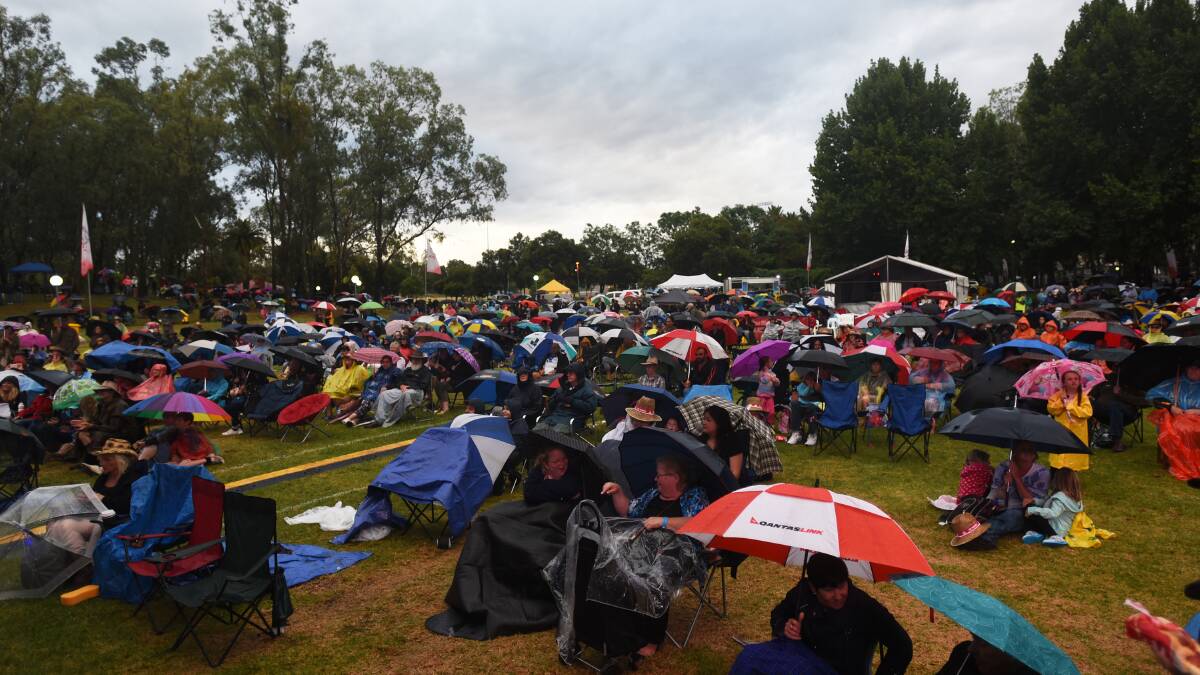 WET BUT KEEN: It might have been a wet welcome to the 2016 Tamworth Country Music Festival – but a little bit of rain doesn’t deter most festival fans. Despite the soggy start to the official 10-day festival on Friday night, about 3000 still turned up to the opening concert and fireworks in Bicentennial Park, despite up to 20mm of rain that day.  And while there’s been some pleasant summer weather over the weekend, the temperatures are tipped to hot up as the week goes on. Photo: Gareth Gardner  150116GGE28