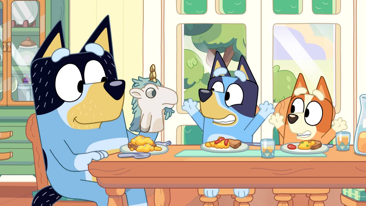 Bandit entertains Bluey and Bingo at the dining table. Picture: ABC Kids