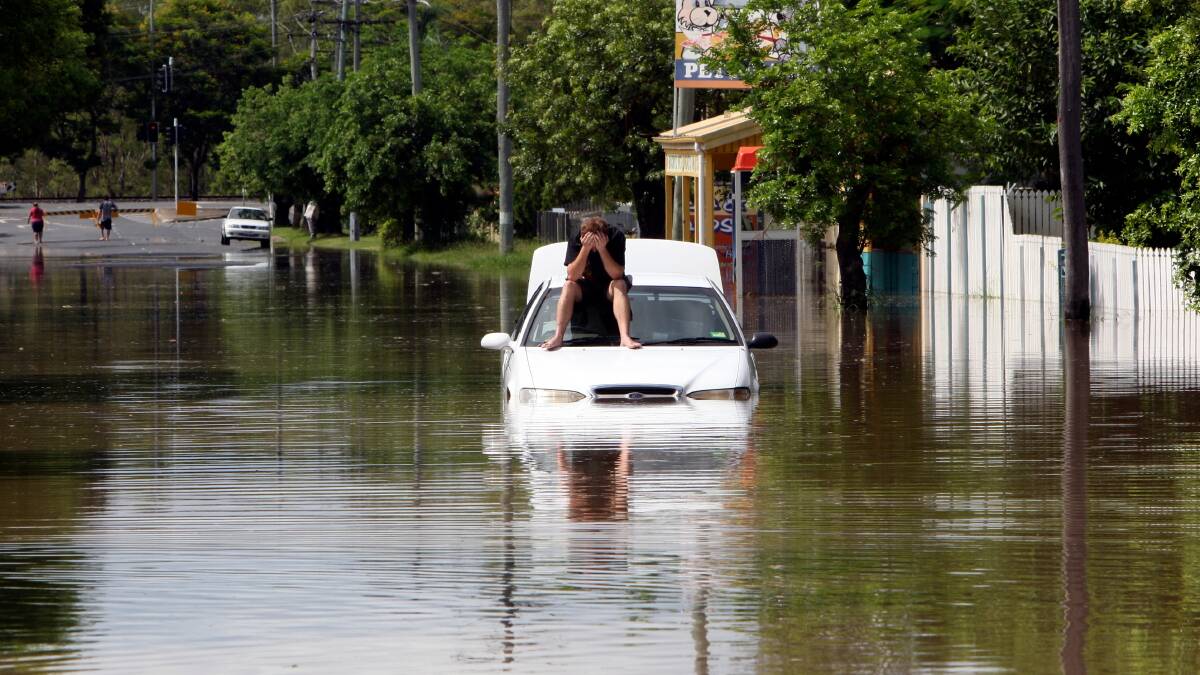A man awaits rescue from floodwaters in Rockhampton in 2011.