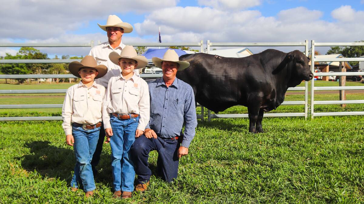 Lindsay Barlow and his sons Braden, 8, and Declan, 9, celebrate their purchase of sale topping Telpara Hills Business Class 302Q, with Stephen Pearce, Telpara Hills.