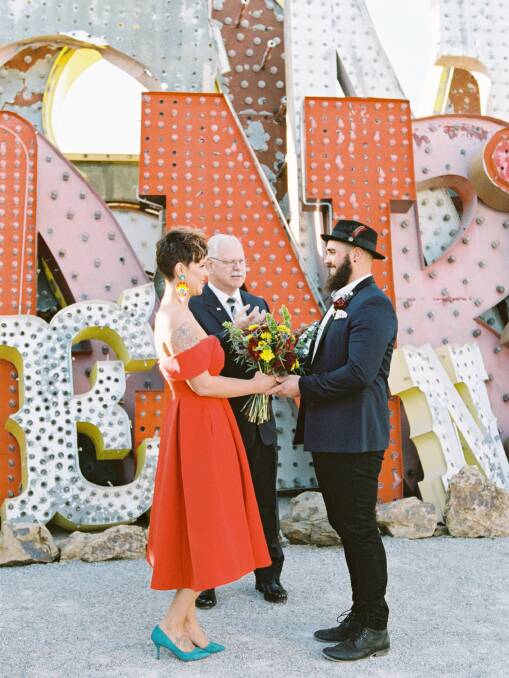Kady and Sam Capewell eloped at The Neon Museum in Las Vegas, with just Pastor Pete as their audience. Photo: Gaby J Photography