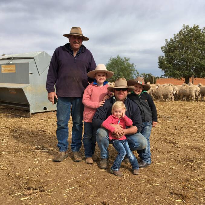 Greg Pollard, Wentworth in one of their drought feedlots with son Ben and grandchildren Cody, 7, Laney, 2 and Sonny, 5. Photo: Supplied 