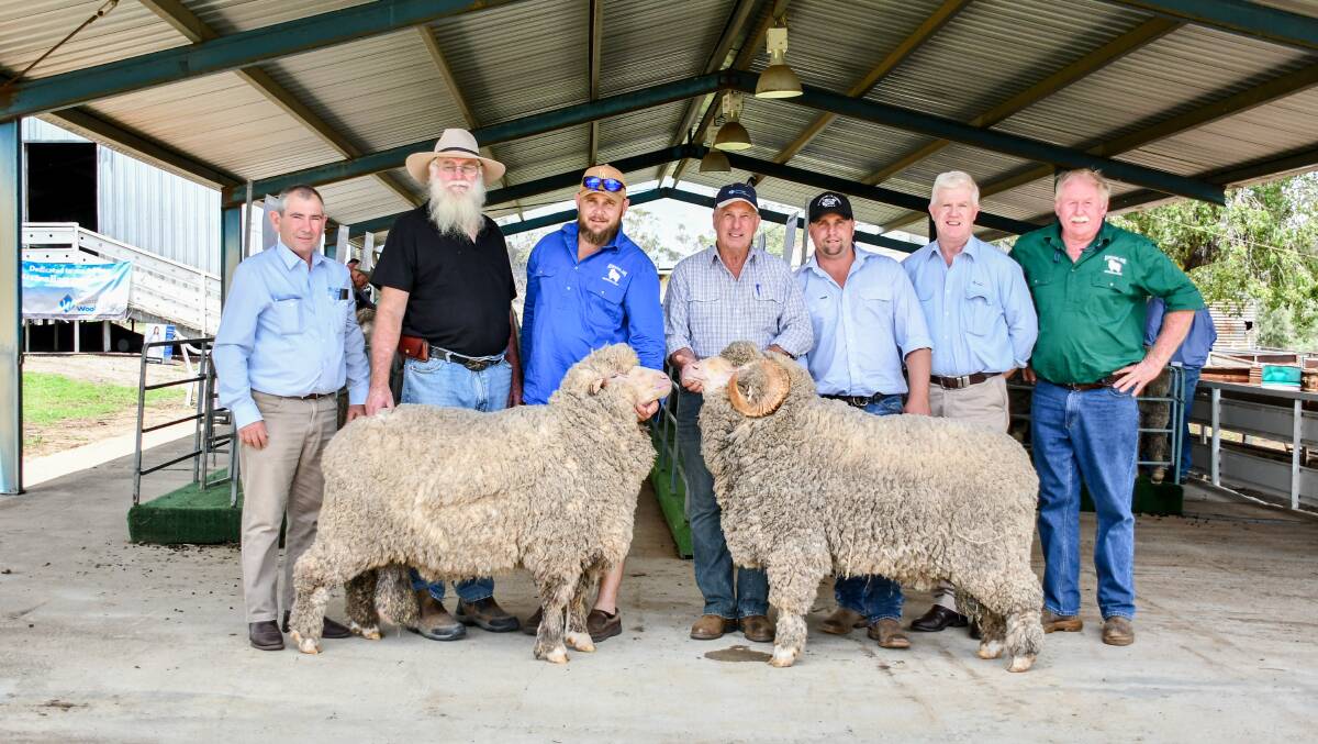 The top price of $1400 was reached three times between buyers David Stewart (second from left), Ashford, and Geoff Swain (fourth from right), Nundle. They are pictured with agents and vendor representatives. 