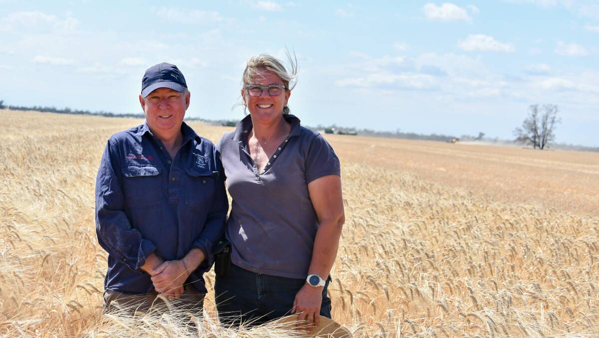Qantas pilot Lindsay Menkens with Vicki Gall of Wallambah, Moree, during barley harvest. 