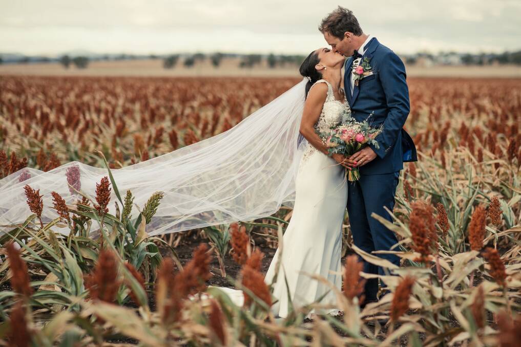 Prim and James Wyatt in a crop of sorghum on their wedding day at Levondale on the Liverpool Plains.