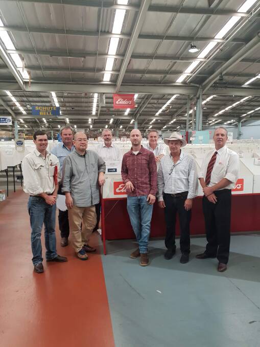 Brad Cavanagh, John Fitzgerald, Sean Tobe, Graham Opie, Josh Clayton, Tim Marwedel, Paul O'Connor, and Tim McMeekin, at the Sydney wool sale where the bale was sold for 2000c/kg. 