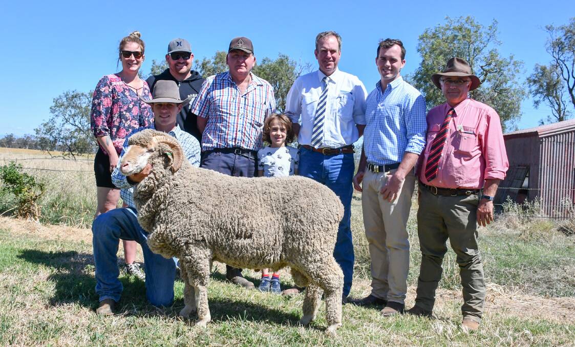 Angus Capel of Bungulla holds the $6500 ram with buyers Anne Brazier, Wade Robinson, Max Leabeater and Brain Brazier of Wombang, Euchareena, auctioneer Paul Dooley, Bungulla's Jock Capel and Elders agent Scott Thrift. 