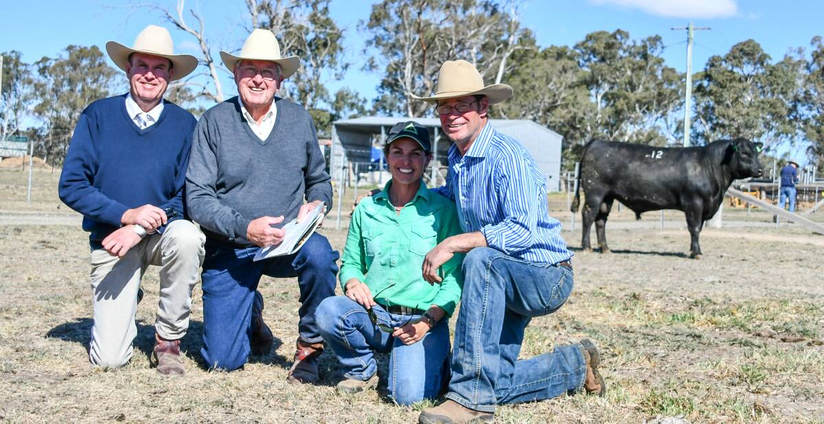 The $28,000 second top price bull was purchased by Anthony Gow-Gates who wasn't present on the day. Pictured is auctioneer Paul Dooley, bidder Rob Vickery, Bective Station, Tamworth, and vendors Erica and Stu Halliday. 