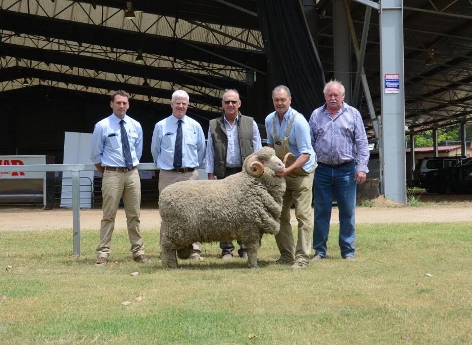 The $15,500 ram from Merryville stud, Boorowa, with AWN's Andy Carter and John Croake, buyer Graeme Newnham, vendor George Merriman and event president Rodney Kent. Photo: Matthew Campion 