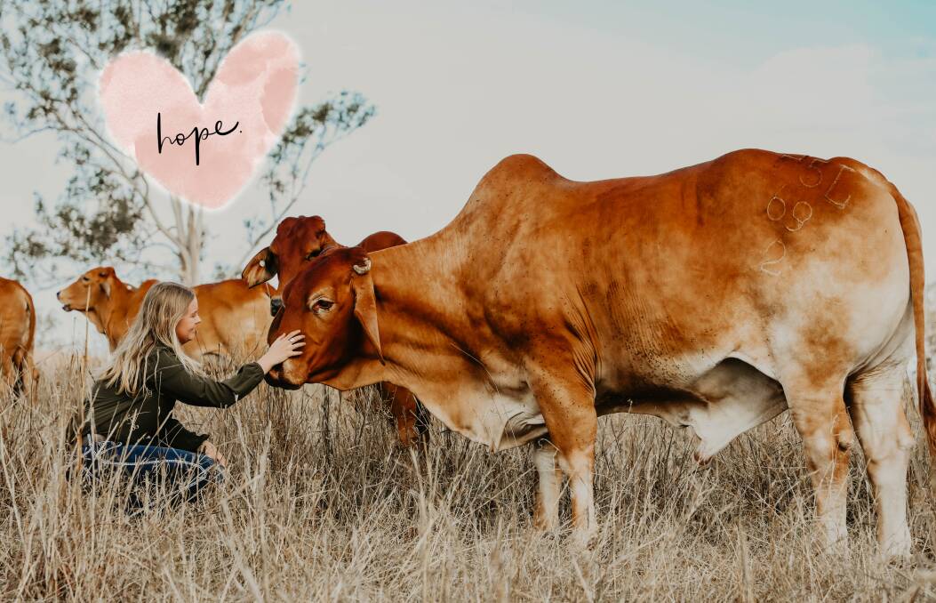 Lucy Kinbacher with her pet steer, Ed-e, and the small love heart that fell out of a significant letter. Photo: Isabella M Photography 