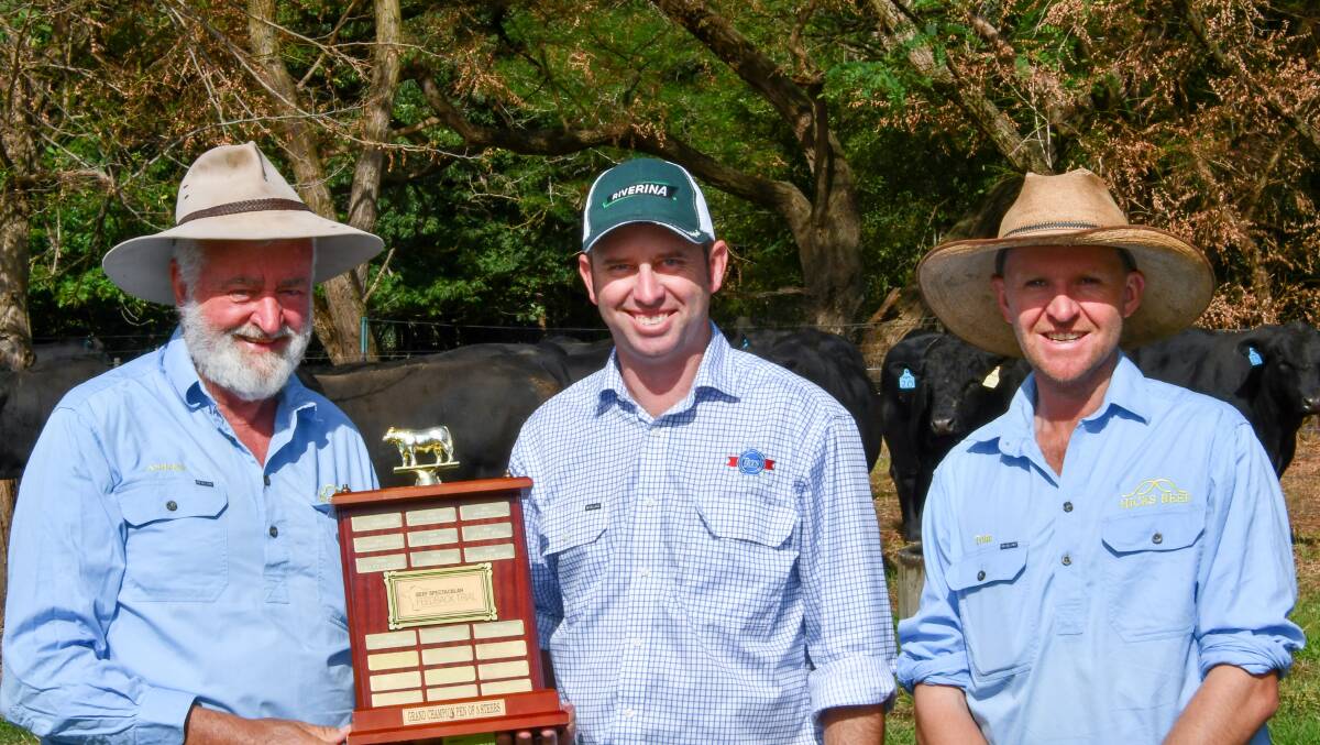 Andrew and Tom Hicks of Hicks Beef at Holbrook are presented their trophy by Teys Jindalee feedlot manager Shane Bullock (centre). Photo: Brett Tindal 