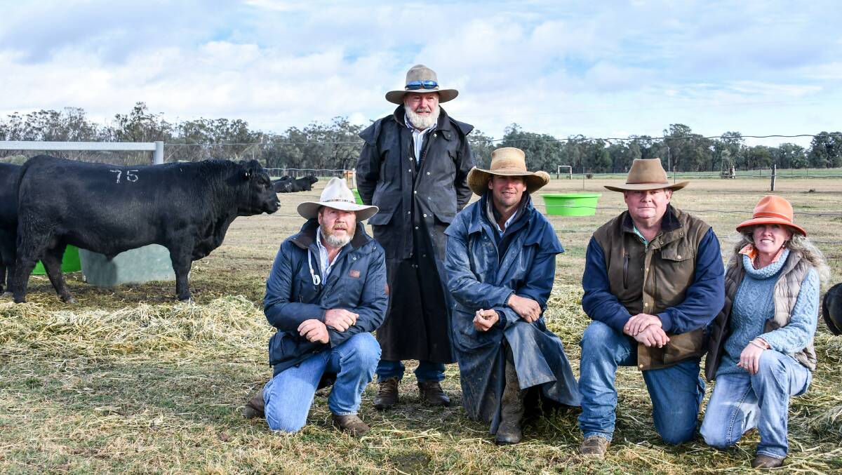 The top price bull with Brett and Hugh Guest and Ben Graham of Clunie Range with buyers Rob Costello and Jo Barr of Nairn Park Angus, Walcha. 